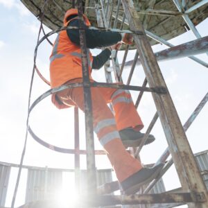full shot man with safety equipment ladder